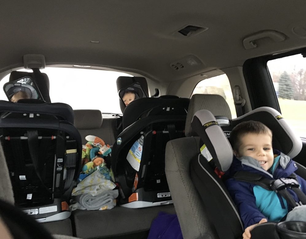 two rear facing car seats and one forward facing car seat in our honda odyssey