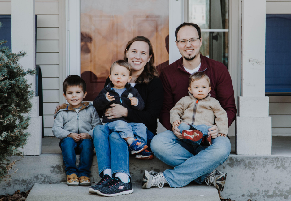 photo of the way it really is family in front of their home