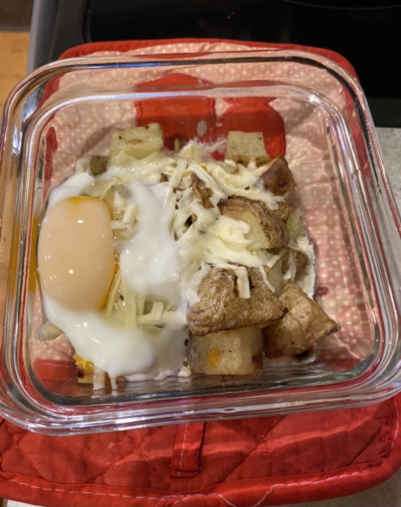 Over easy egg on top of potatoes