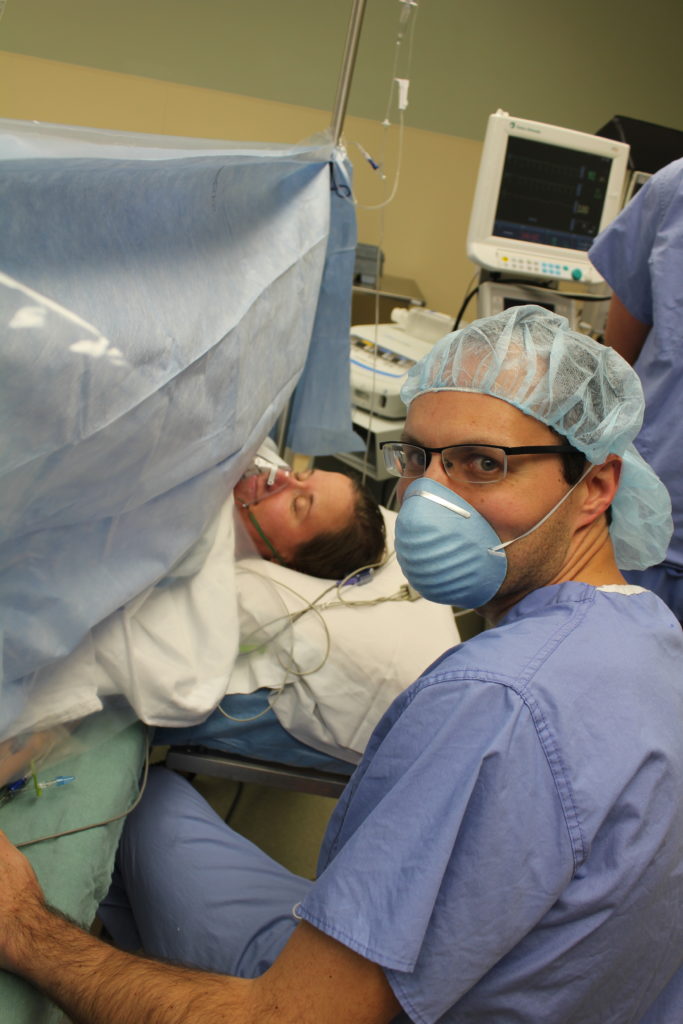 Picture of me / my head during my c-section and my husband looking at the camera.