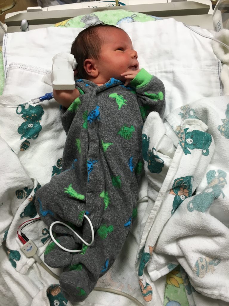 baby hooked up to wires and tubes in NICU