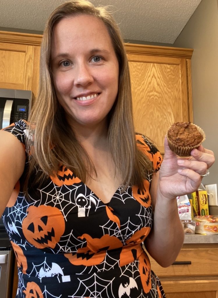 me in my halloween dress holding a pumpkin muffin