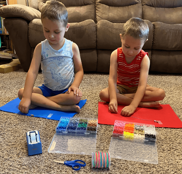 Kids making bead bracelets