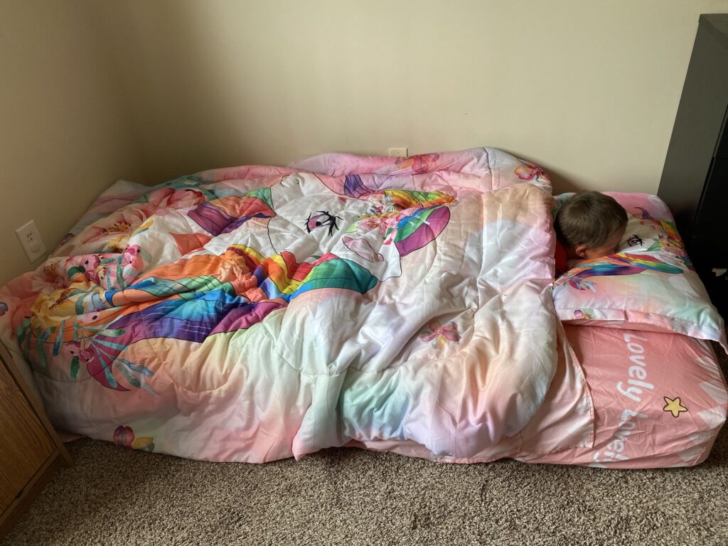 One of my twins sleeping on his new twin size mattress on the floor before his twin bed frame arrived.