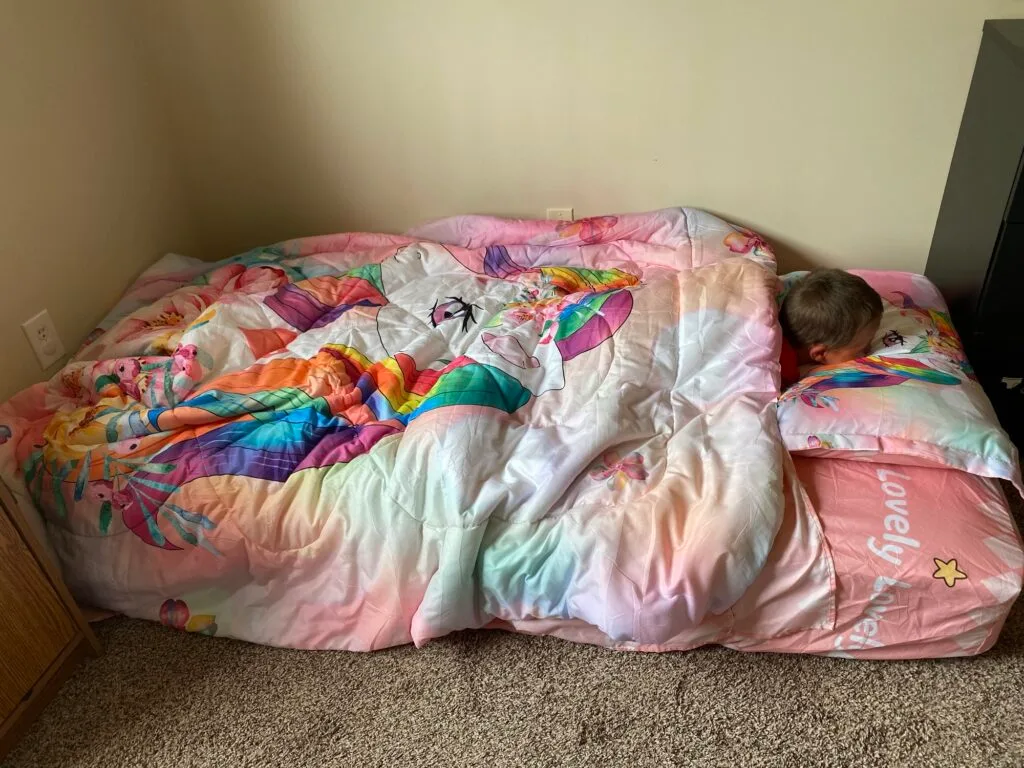 One of my twins sleeping on his new twin size mattress on the floor before his twin bed frame arrived.
