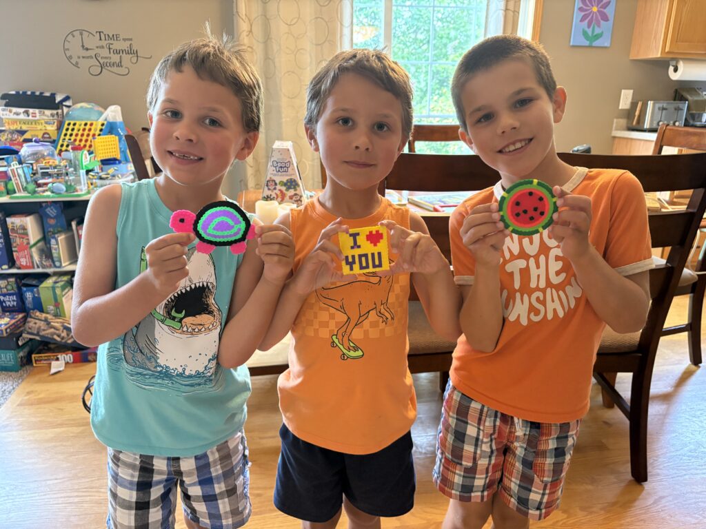 My boys holding up their first perler beads creations