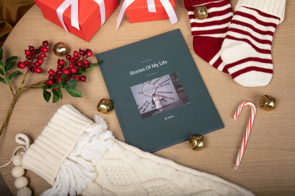 Remento memory book surrounded by Christmas decorations including stockings, gifts, bells, and a candy cane.